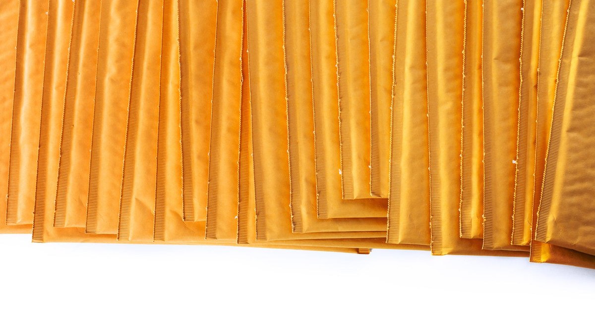 A row of overlapping brown padded envelopes on a white background.